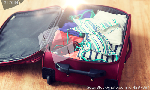 Image of close up of travel bag with beach clothes