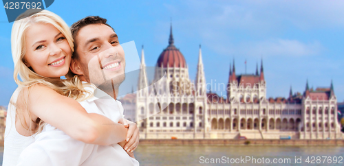 Image of happy couple over house of parliament in budapest