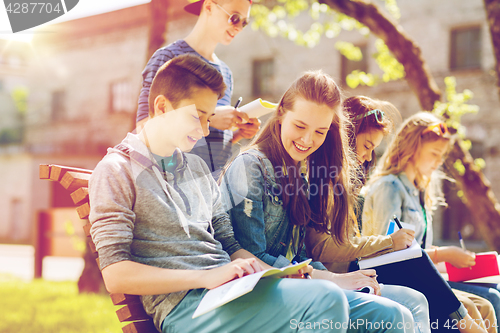 Image of group of students with notebooks at school yard