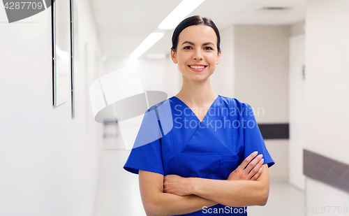 Image of happy doctor or nurse at hospital corridor