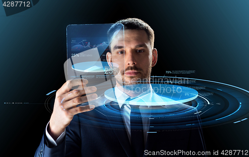 Image of businessman with tablet pc and virtual charts