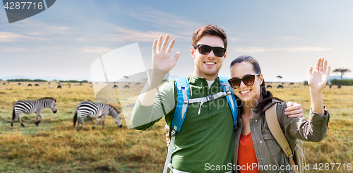 Image of smiling couple with backpacks traveling in africa