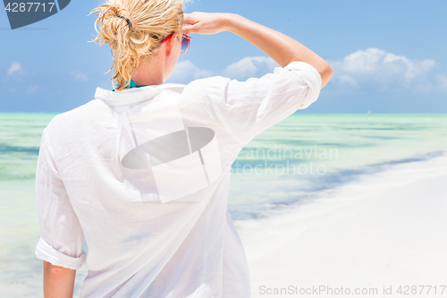 Image of Happy woman enjoying, relaxing joyfully in summer on tropical beach.