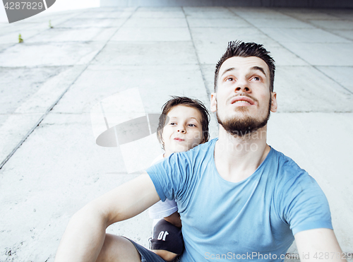 Image of young pretty man model with little cute son playing together, li