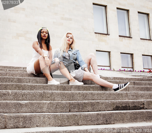Image of Two teenage girls infront of university building smiling, having fun traveling europe, lifestyle people concept 