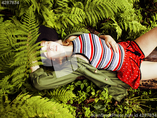 Image of Pretty young blond girl hipster in hat among fern, vacation in green forest, lifestyle fashion people concept