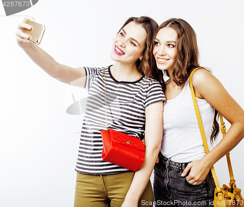 Image of best friends teenage girls together having fun, posing emotional on white background, besties happy smiling, lifestyle people concept close up. making selfie