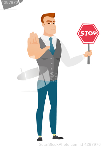 Image of Caucasian businessman holding stop road sign.