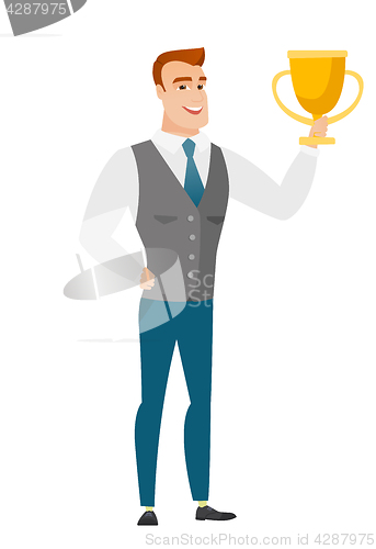 Image of Caucasian business man holding a trophy.