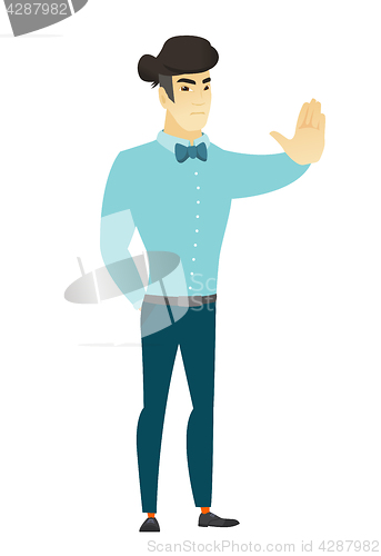 Image of Asian businessman showing stop hand gesture.