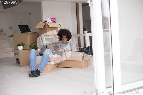 Image of African American couple  playing with packing material