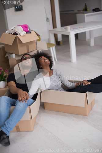 Image of African American couple  playing with packing material