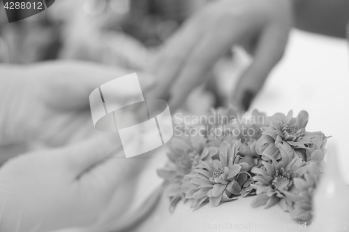 Image of Woman hands receiving a manicure