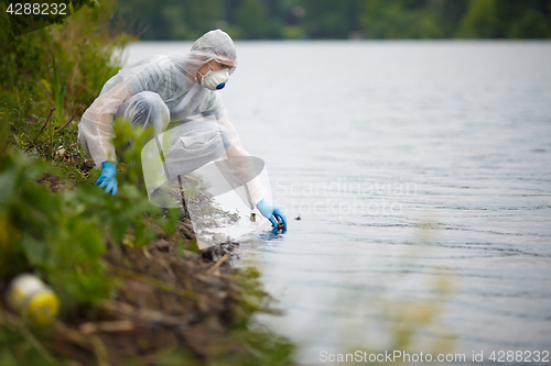 Image of Biologist with bulb on river