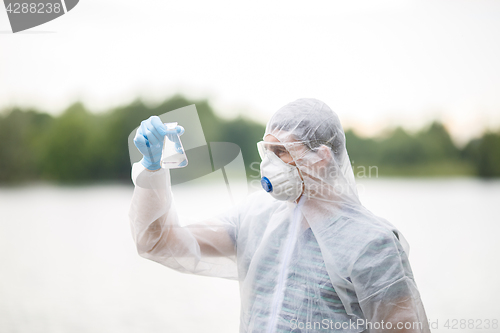 Image of Ecologist holds flask with water