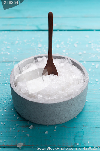 Image of sea salt on wooden background