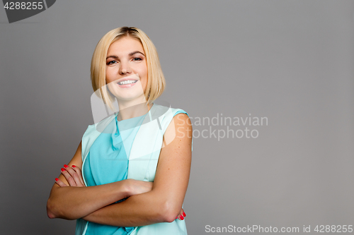 Image of Beautiful blonde with arms crossed