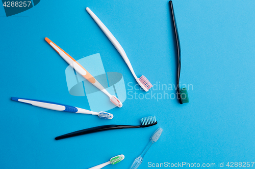 Image of Colored toothbrushs arranged in semicircle