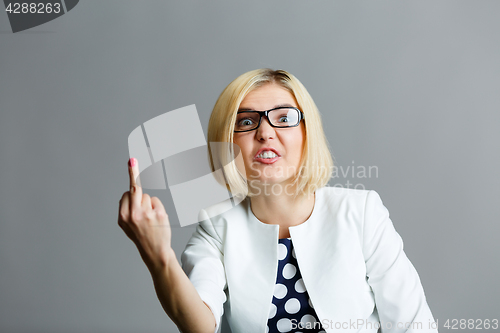 Image of Smiling girl showing middle finger