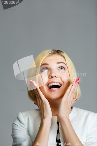 Image of Smiling young blonde looks up