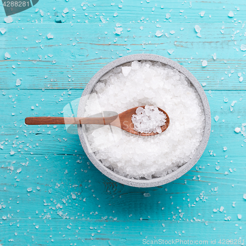 Image of sea salt on wooden background