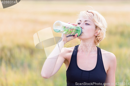 Image of Fitness woman drinking water