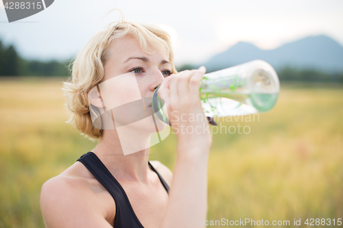 Image of Fitness woman drinking water