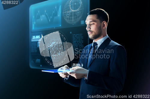 Image of businessman in suit with transparent tablet pc