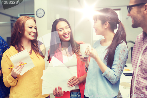 Image of creative team on coffee break talking at office