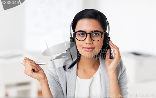 Image of businesswoman with headset talking at office