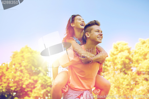 Image of happy teenage couple having fun at summer park