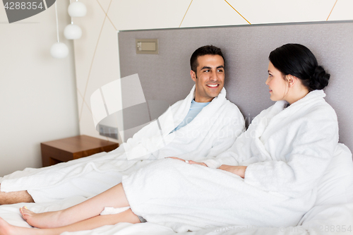 Image of happy couple in bed at home or hotel room