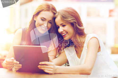 Image of happy young women or teenage girls with tablet pc