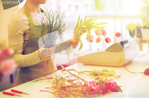 Image of close up of florist making bunch at flower shop