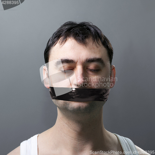 Image of man with duck tape on face