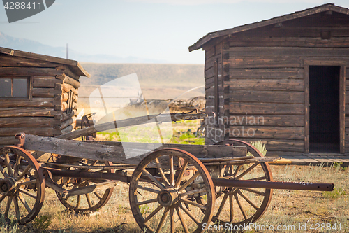 Image of Abstract of Vintage Antique Wood Wagon and Log Cabins.