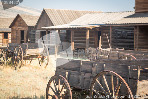 Image of Abstract of Vintage Antique Wood Wagon and Log Cabins.