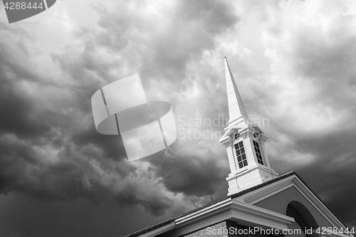 Image of Black and White Church Steeple Tower Below Ominous Stormy Thunde