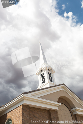 Image of Church Steeple Tower Below Ominous Stormy Thunderstorm Clouds.