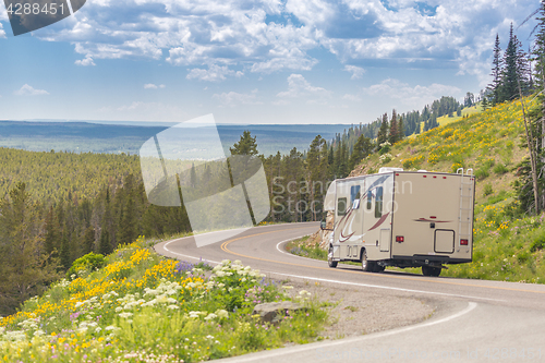 Image of Camper Driving Down Road in The Beautiful Countryside Among Pine