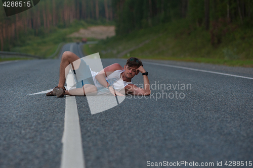 Image of Man laying on the road