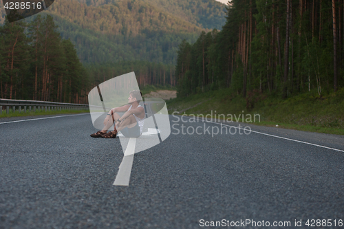 Image of Man sitting on the road
