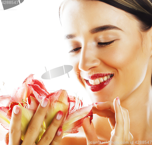 Image of young pretty brunette woman with red flower amaryllis close up i