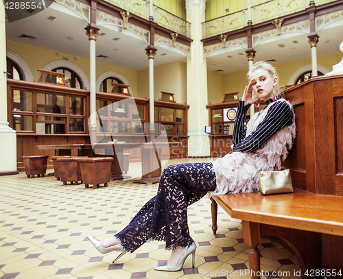 Image of young attractive fashion lady on railway station waiting, vintag