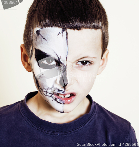 Image of little cute boy with facepaint like skeleton to celebrate hallow