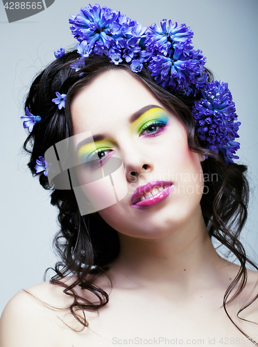 Image of Beauty young woman with flowers and make up close up, real sprin