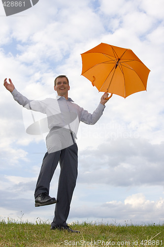 Image of Happy businessman with orange umbrella