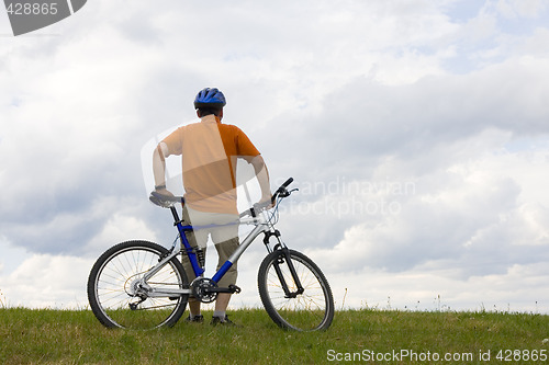 Image of Man standing by his mountain bike