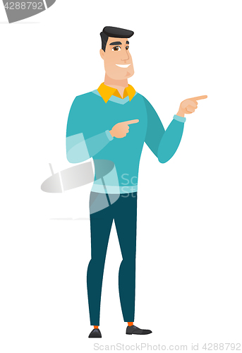 Image of Young caucasian businessman pointing to the side.