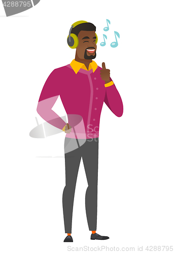 Image of Businessman listening to music in headphones.